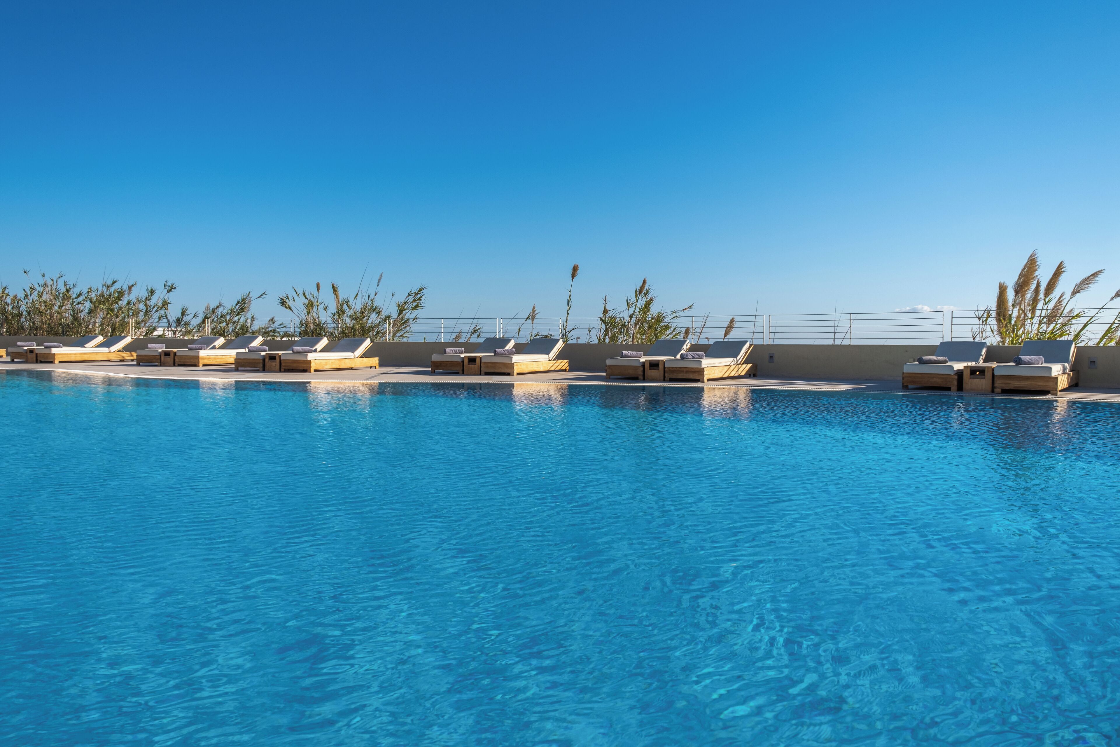 seasonal outdoor pool, pool umbrellas, pool loungers