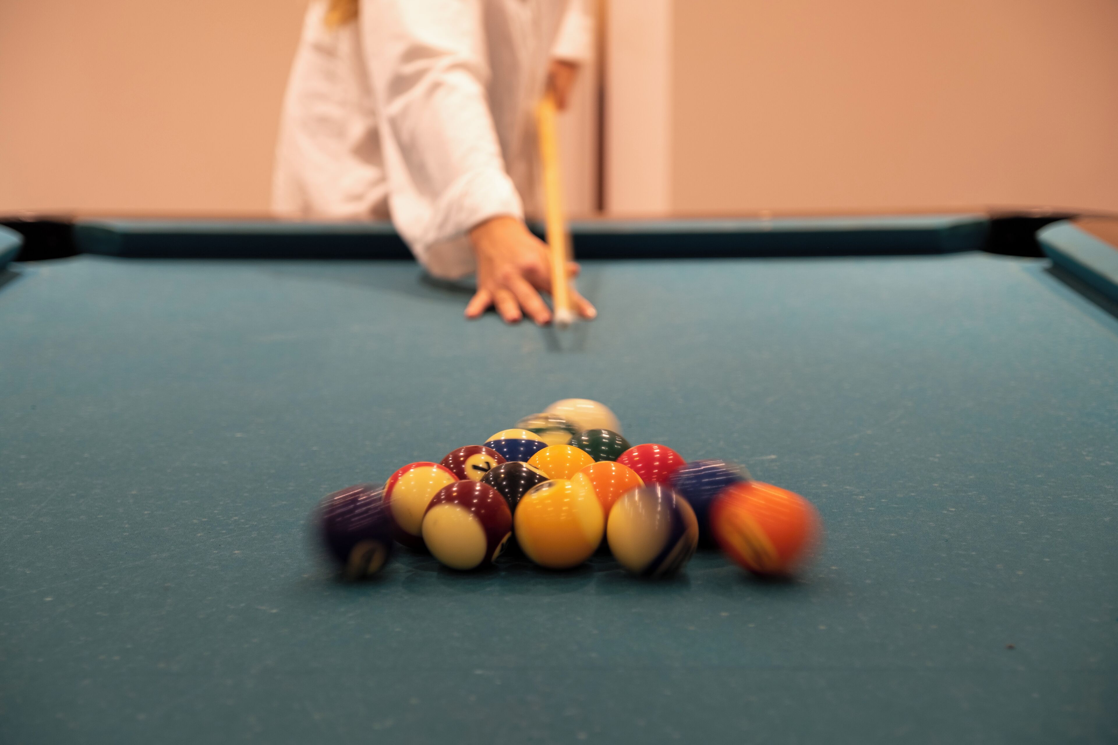 A pool table with balls arranged in a triangle formation.