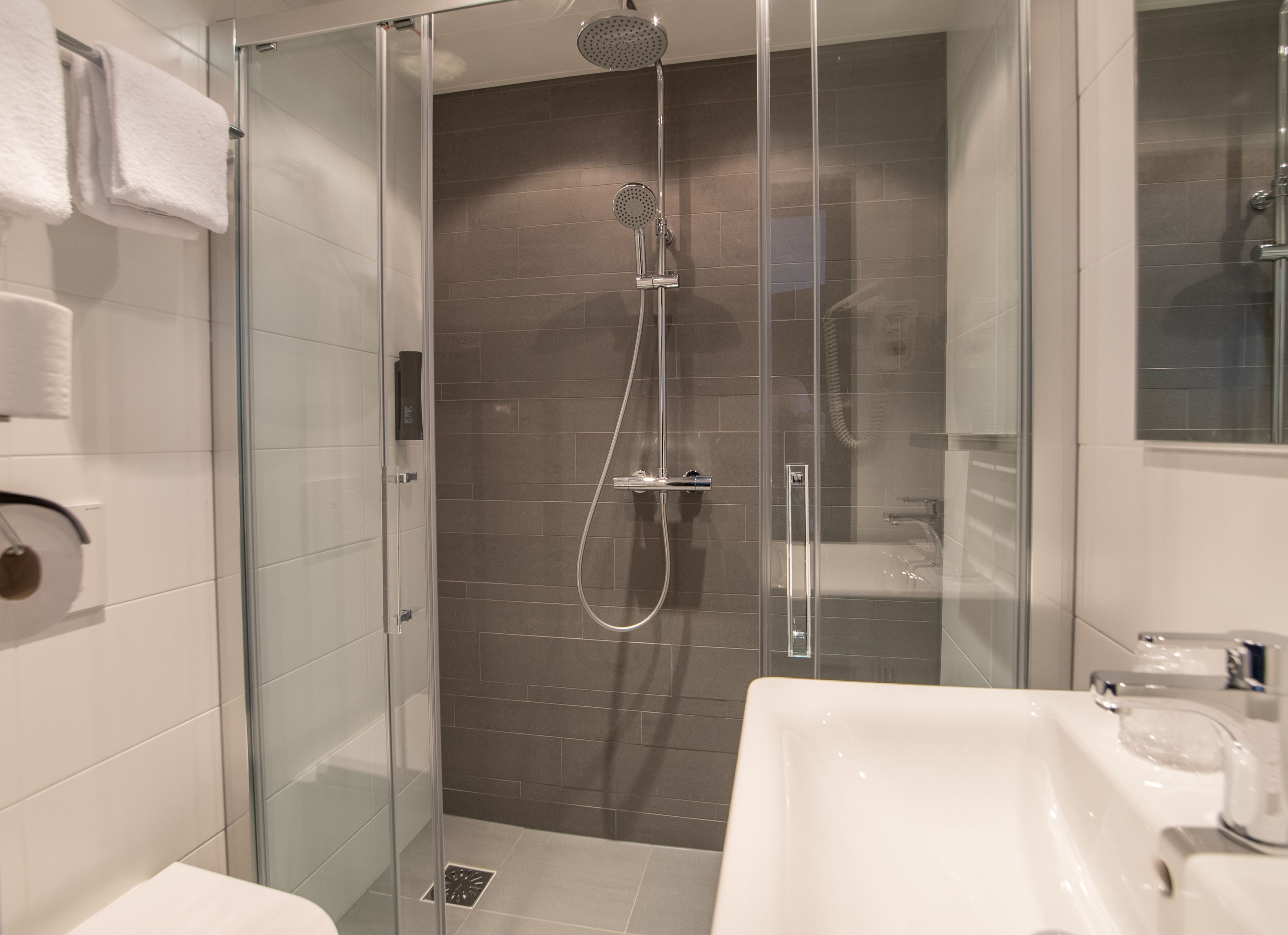 superior room | bathroom | shower, hair dryer, towels