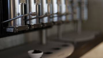 A coffee machine with multiple dispensers, each labeled with different types of coffee.