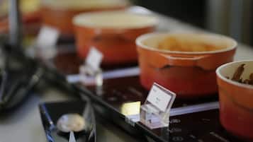A display of red bowls with a sign indicating a price of $5.00.