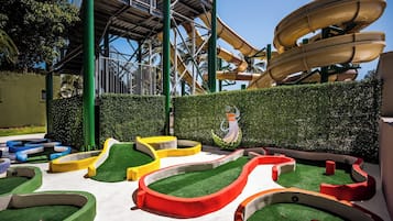 Enjoy thrilling water slides and play structures amidst lush artificial turf and winding pathways.