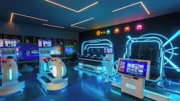 A VR gaming room with multiple VR headsets, a console, and neon signage.