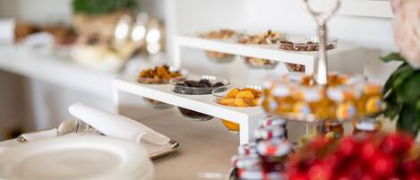 A buffet setup with various food items on tiered serving trays.