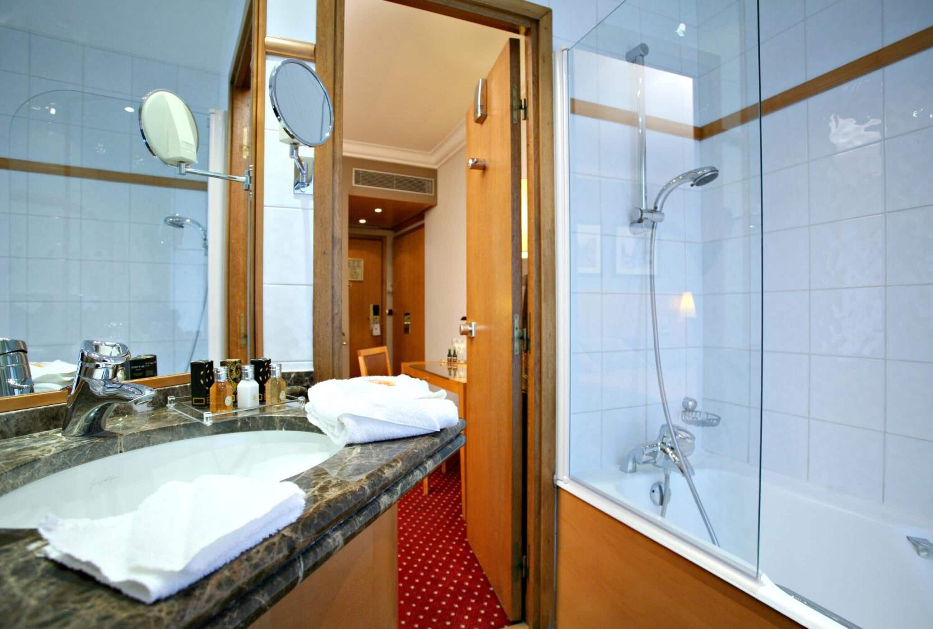 deluxe double room | bathroom | deep-soaking bathtub, rainfall showerhead, free toiletries, hair dryer