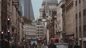 A busy city street with historic buildings, a prominent dome, and modern skyscrapers in the background. - Leonardo Hotel London Croydon (Croydon)