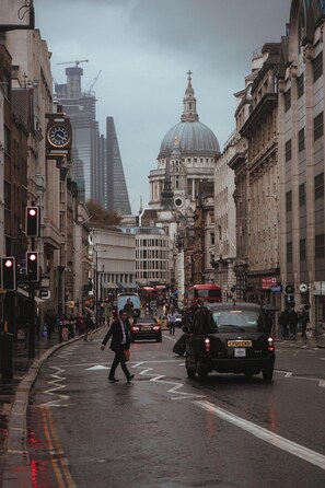 A busy city street with historic buildings, a prominent dome, and modern skyscrapers in the background. - Leonardo Hotel London Croydon (Croydon)