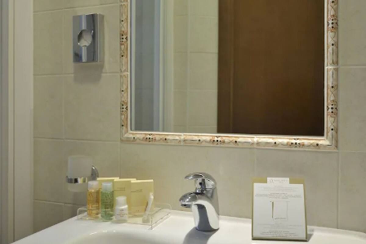 designer toiletries, hair dryer, slippers, bidet