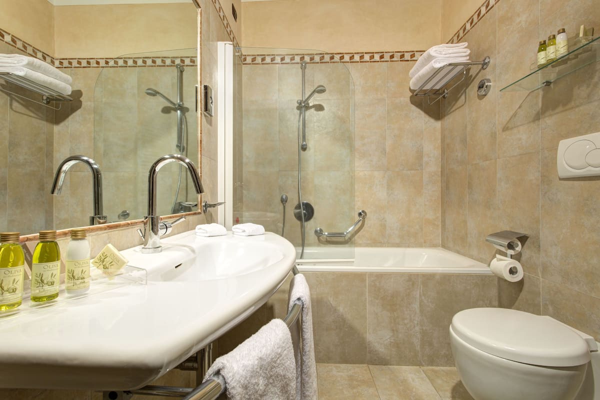 designer toiletries, hair dryer, slippers, bidet