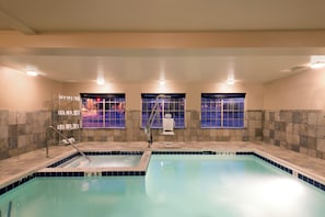 A swimming pool with a ladder, a window with a view, and a towel rack. - Holiday Inn Express & Suites Fraser - Winter Park Area by IHG (Fraser)