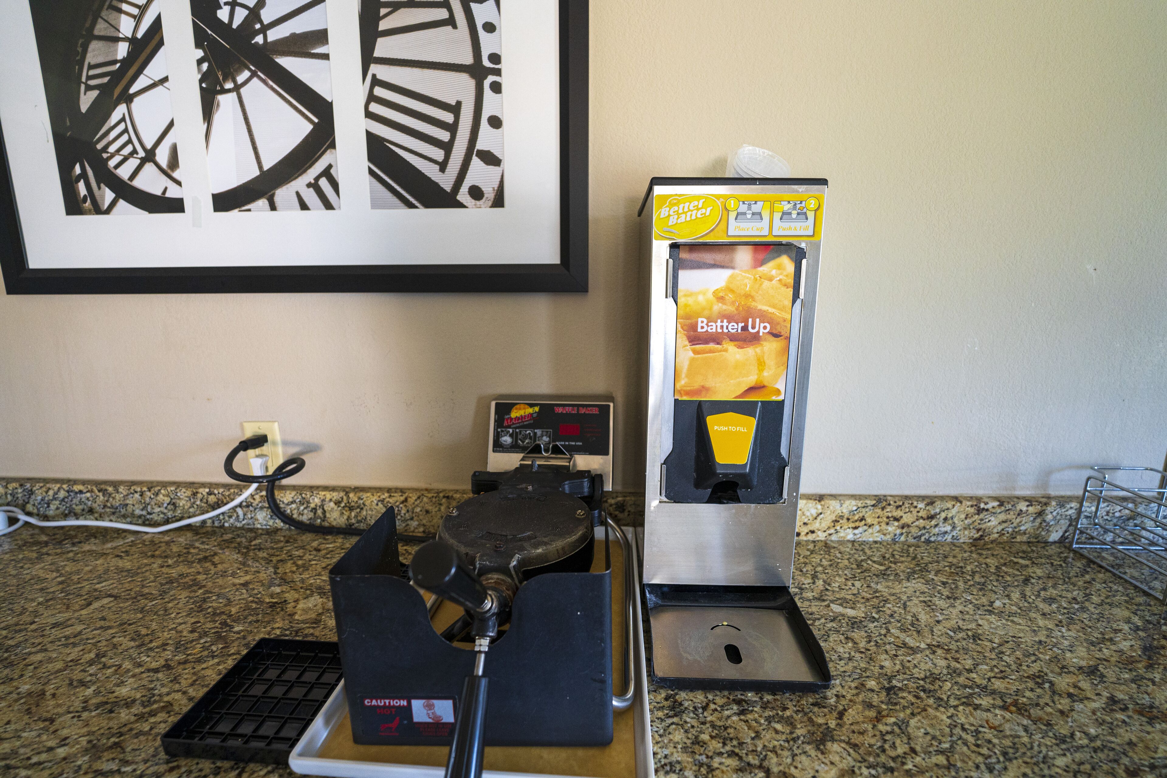 A coffee machine and a food dispenser on a kitchen counter.