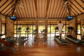 A gym with treadmills, stationary bikes, and weight machines.