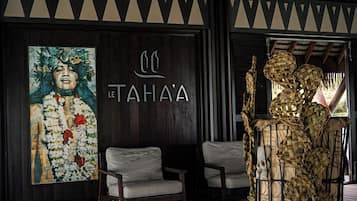A wooden staircase leading to a seating area with a mural and a decorative basket.