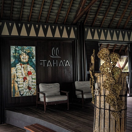 A wooden staircase leading to a seating area with a mural and a decorative basket.