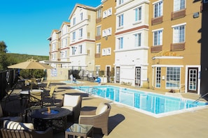 A poolside area with outdoor seating and a swimming pool.