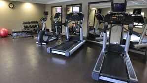 A gym with treadmills, a stationary bike, and a red exercise ball. - Staybridge Suites Silicon Valley by IHG (Milpitas)