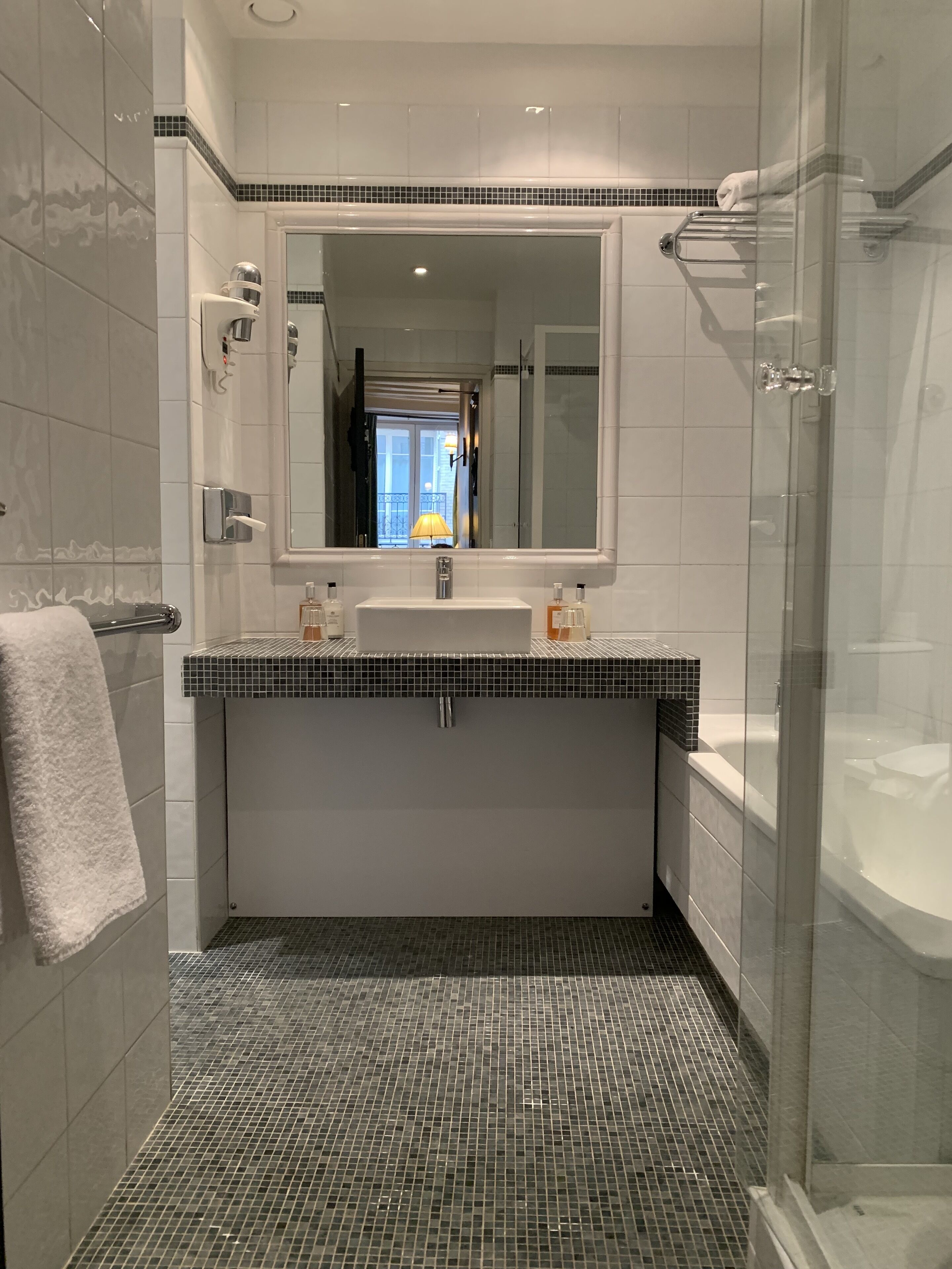 shower, hair dryer, towels, shampoo