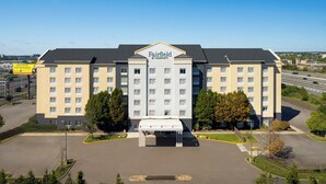 A Fairfield by Marriott hotel with a central entrance, multiple floors, and a parking lot.