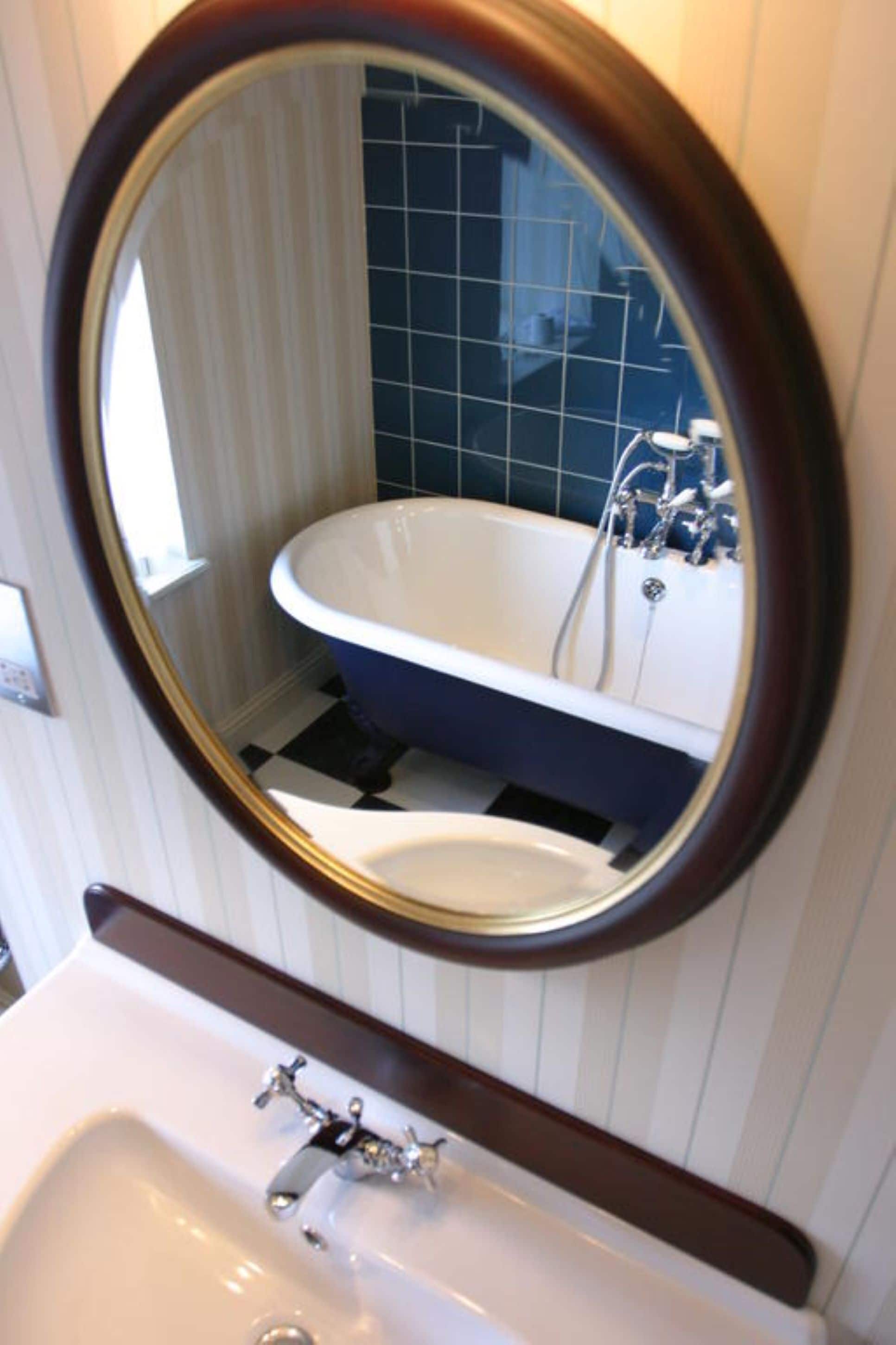 A bathroom with a white sink, a mirror, and a bathtub.
