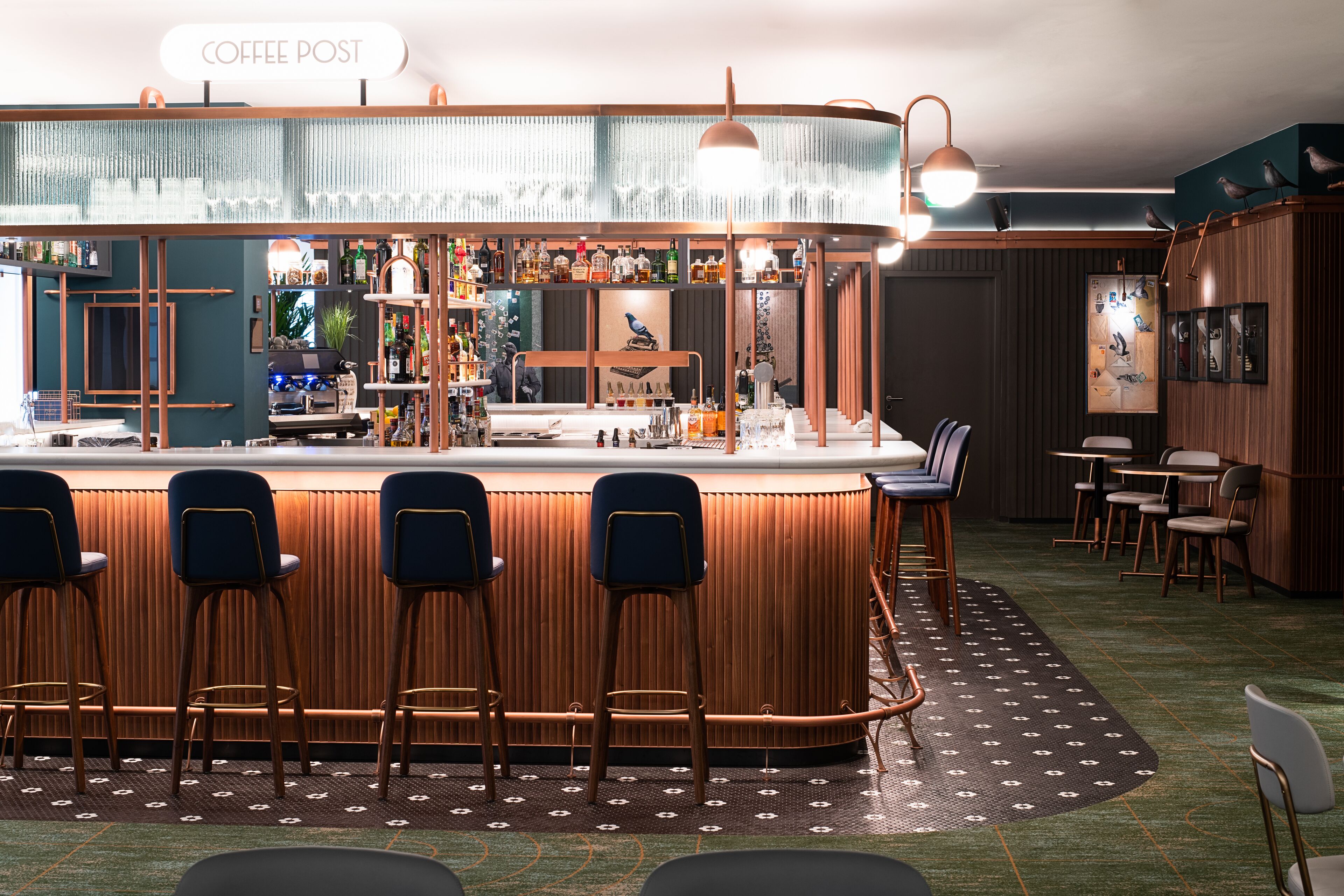 A bar area with stools, a counter, and a sign that reads "COFFEE POST".