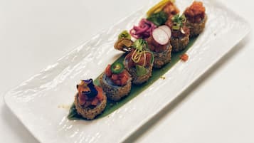 A rectangular white plate with a food arrangement.