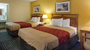 A hotel room with two beds, a nightstand with a lamp, a telephone, and a painting on the wall. - Econo Lodge Petersburg - Fort Lee (Petersburg)