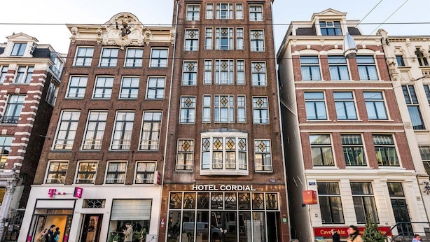 A hotel with a classic facade, large windows, and a prominent entrance. - OZO Hotels Cordial Amsterdam (Amsterdam)