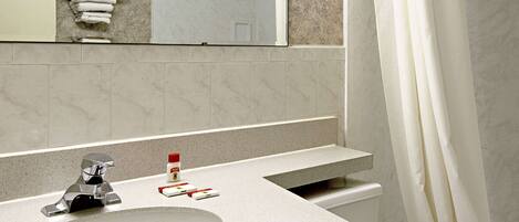 A bathroom with a sink, mirror, and shower curtain.