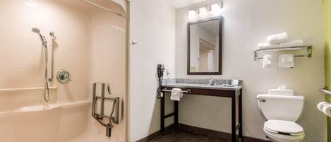 A bathroom with a bathtub, a sink, a toilet, and a mirror.