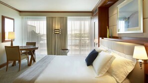 A hotel room with a bed, a desk, and a chair. - Four Seasons Astir Palace Hotel Athens (Vari-Voula-Vouliagmeni)