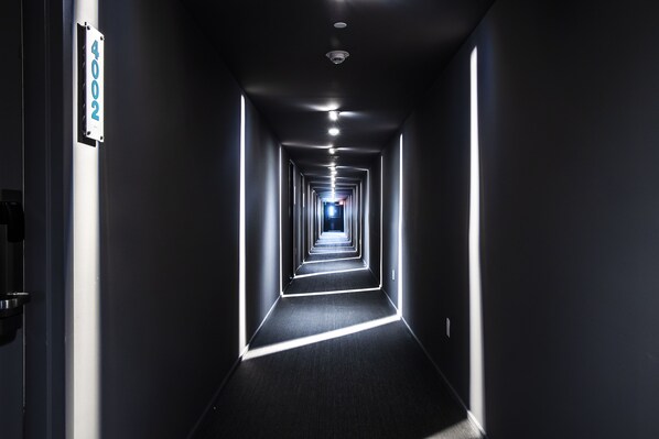 A narrow, well-lit hallway with a sign on the left indicating room number 404.