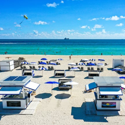 On the beach, white sand, beach umbrellas, beach towels