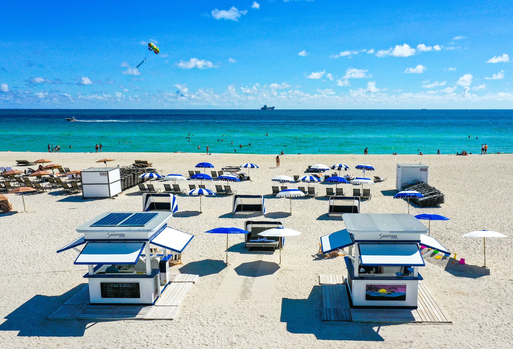 On the beach, white sand, sun loungers, beach towels