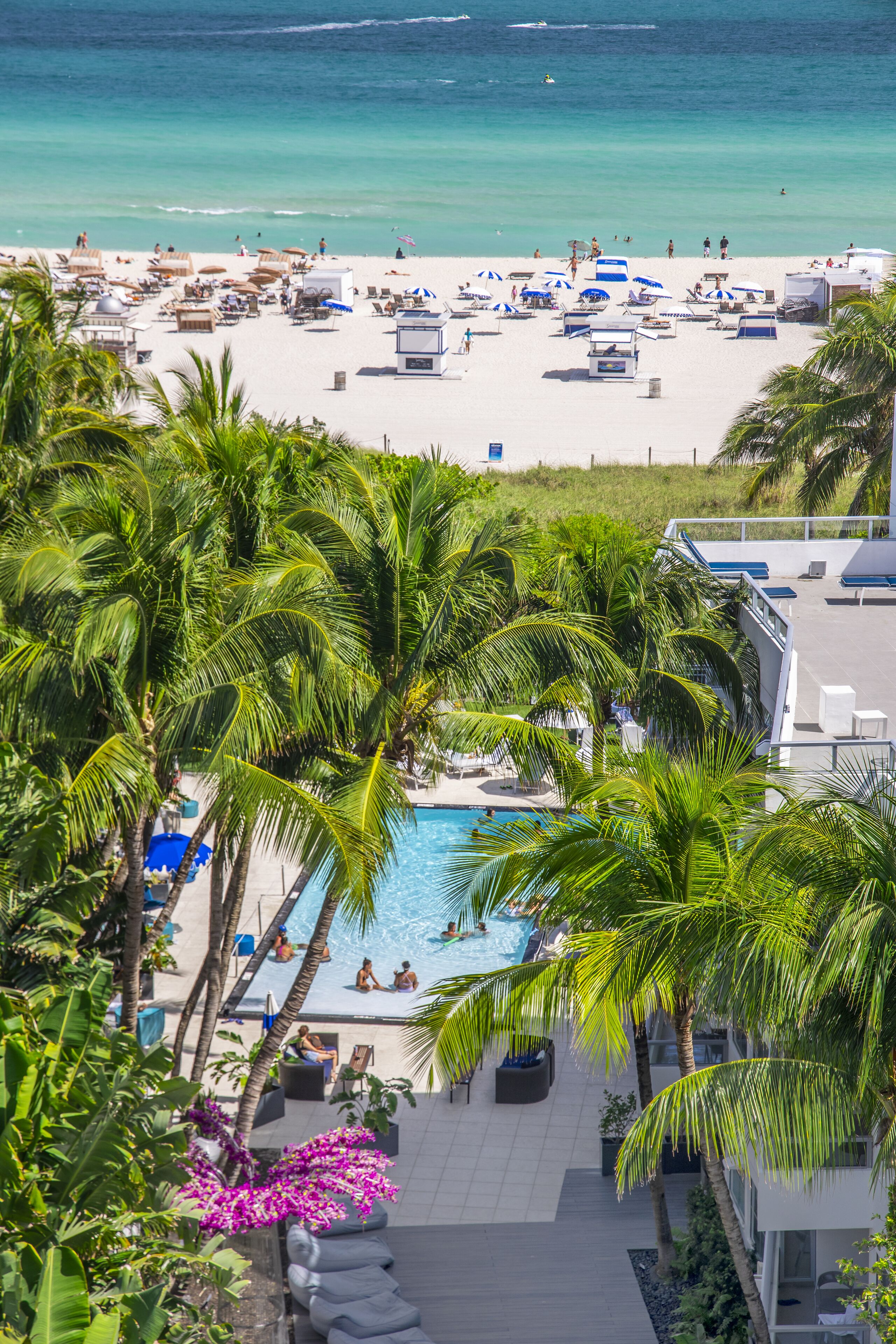 On the beach, white sand, beach umbrellas, beach towels
