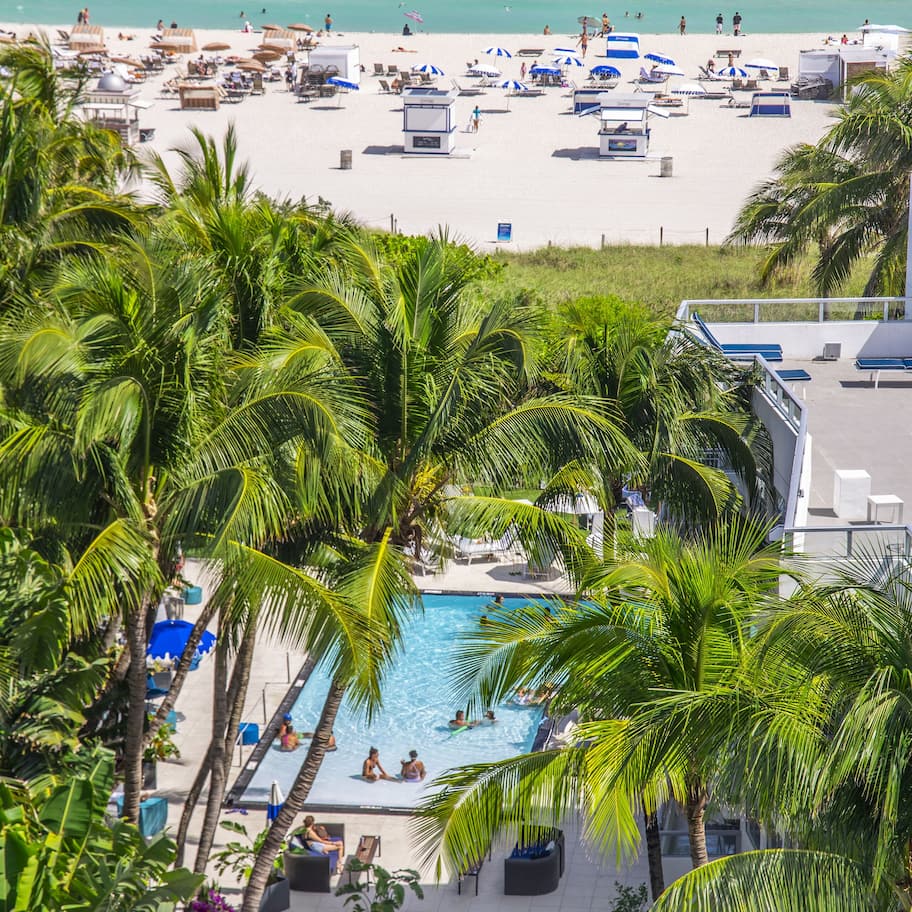On the beach, white sand, beach umbrellas, beach towels