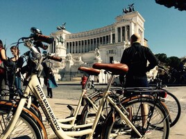 Bicycles parked in front of a historic building with classical architecture.