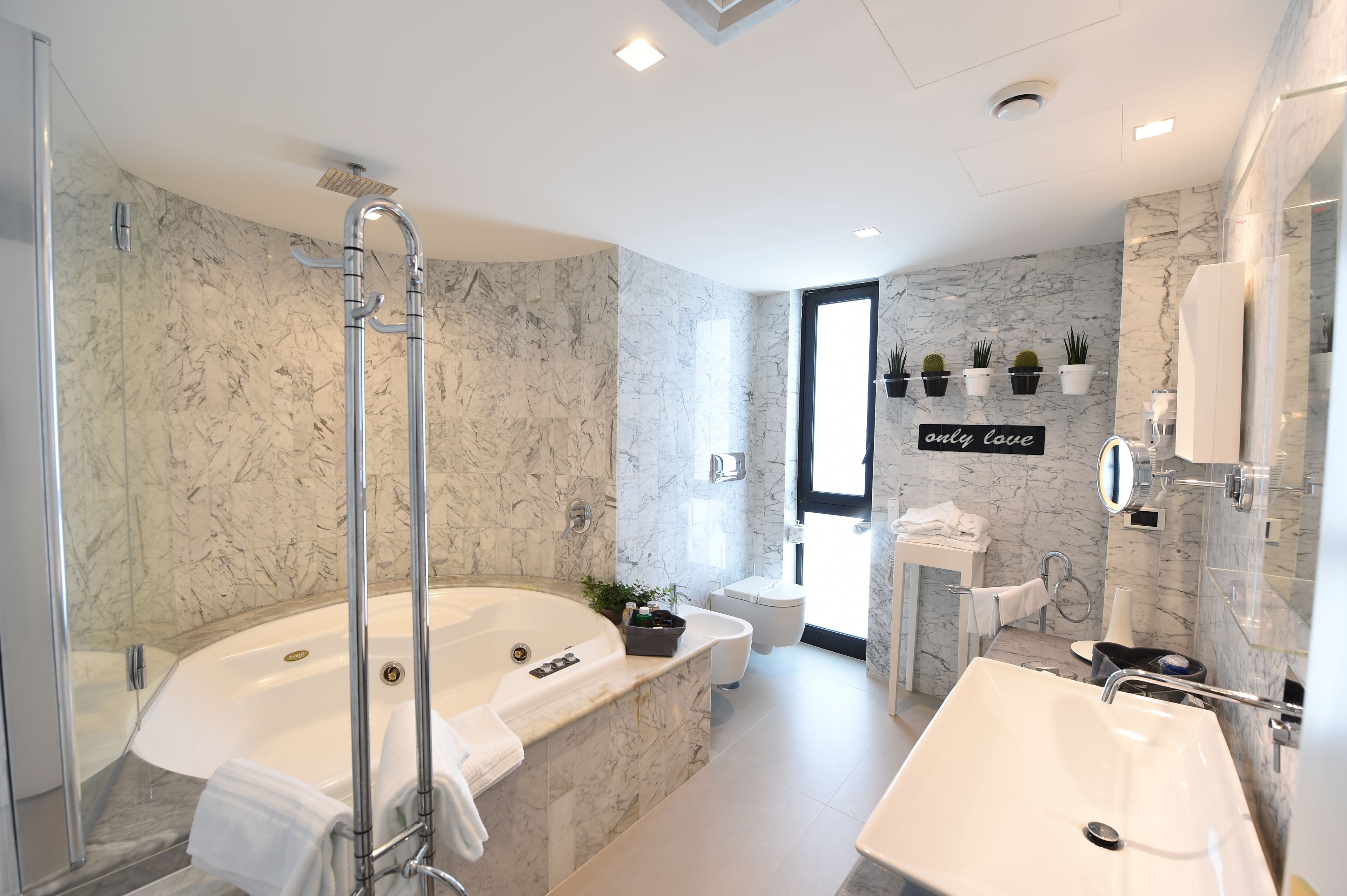 combined shower/bathtub, rainfall showerhead, designer toiletries