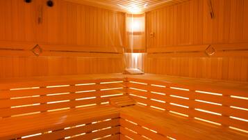 Een sauna met houten banken en een lichtbron in het midden.