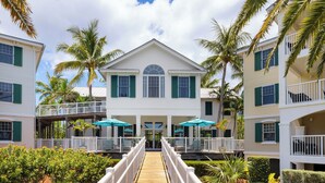A two-story building with a central entrance, surrounded by palm trees and a wooden walkway. - Hyatt Vacation Club at Windward Pointe, Key West (Key West)