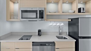 A modern kitchen with a built-in microwave, toaster, and dishwasher. - Towneplace Suites by Marriott Warren (Warren)