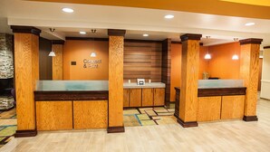 A reception area with wooden paneling, a reception desk, and a wall-mounted sign that reads "Connect & Print".