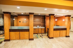 A reception area with wooden paneling, a reception desk, and a wall-mounted sign that reads "Connect & Print".