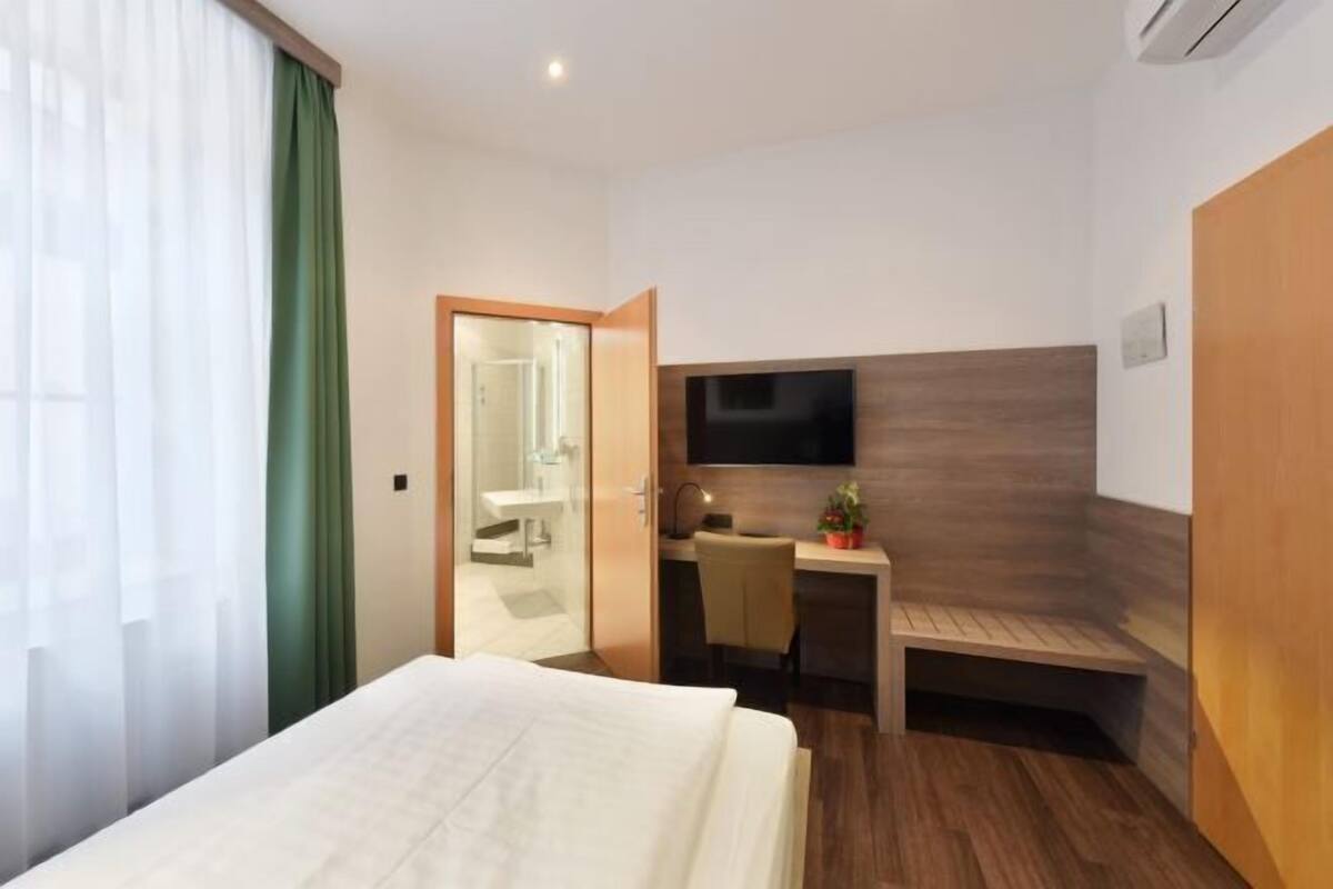 Ropa de cama de alta calidad y caja de seguridad en la habitación