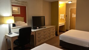 A hotel room with two beds, a desk with a computer, a chair, a dresser, and a mirror. - Econo Lodge Inn & Suites Walnut (Walnut)