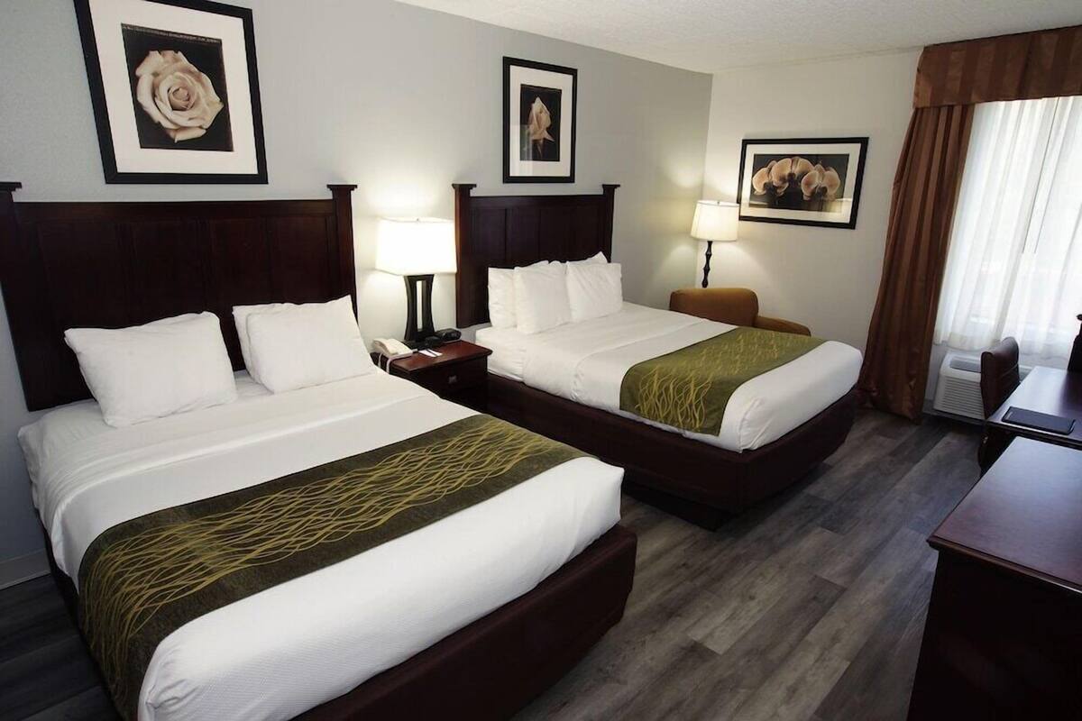 Premium bedding, desk, laptop workspace, blackout drapes