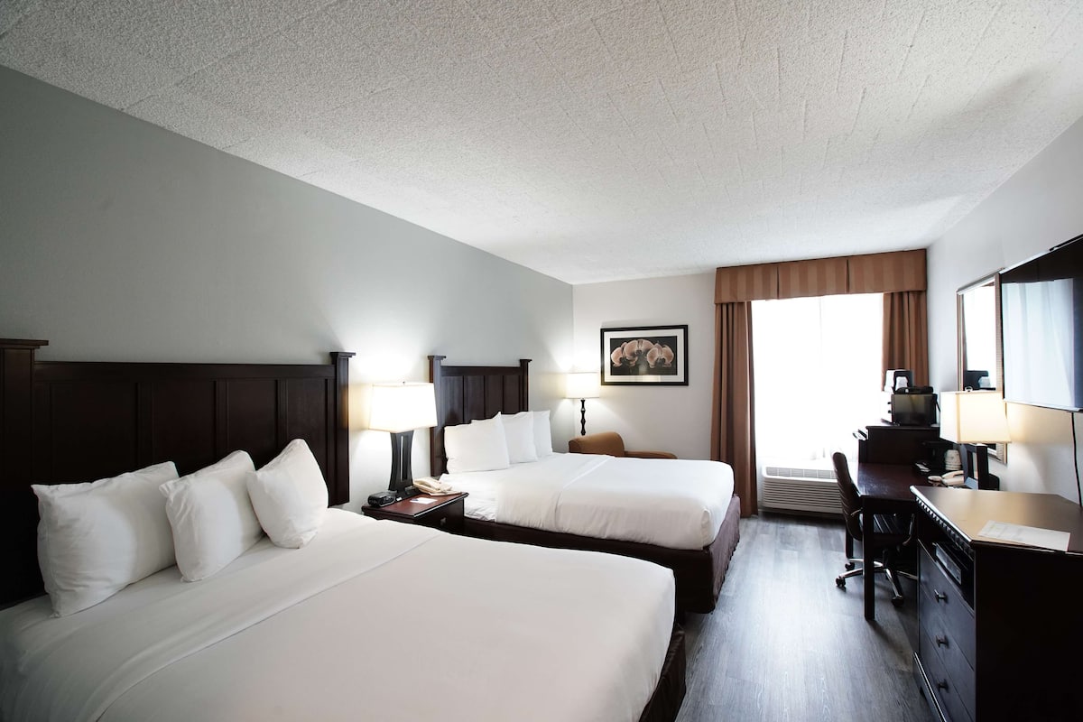 Premium bedding, desk, laptop workspace, blackout drapes