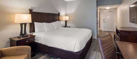 Premium bedding, desk, laptop workspace, blackout drapes
