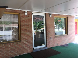 A brick building with a glass door labeled "OFFICE" and a "PRIVATE" sign. - Royal Inn Motel (Front Royal)