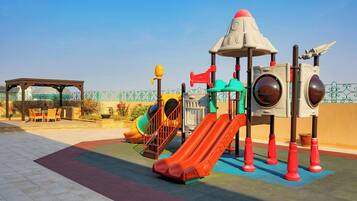 A playground with slides and climbing structures.