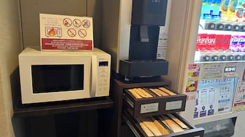 A microwave, a coffee machine, and a QR payment machine in a store.